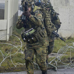Deutsche Soldaten überwinden eine Sperre im Laufschritt. (Foto: Carl Schulze)